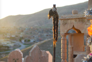 Braids cut off and hang from one of the tombs at Boza cemetery. Traditionally, Yezidi girls and women didn't cut hair unless a loved one passed away. "people would cut off their long braids and place them over the headstones of the loved one, as if to say the beauty in my life left with your departure."